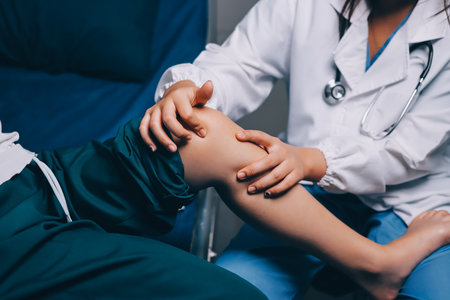 Rehabilitation therapy Professional male physiotherapists working in rehabilitation centers while treating male patients with leg and muscle pain.の写真素材