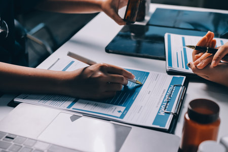 Group of doctors attending seminar in hospital lecture hall with senior physician giving medical presentation and professional training session on healthcare practicesの写真素材