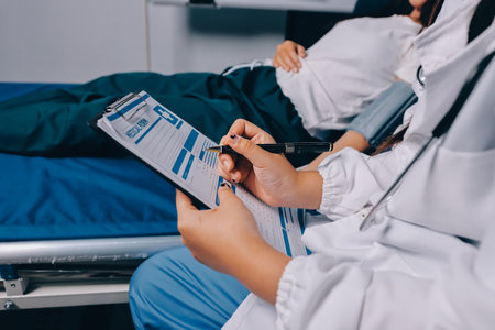 Nurse measuring blood pressure of elderly woman at table, closeup. Assisting senior generationの写真素材
