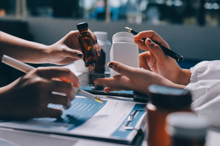 Group of doctors attending seminar in hospital lecture hall with senior physician giving medical presentation and professional training session on healthcare practicesの写真素材