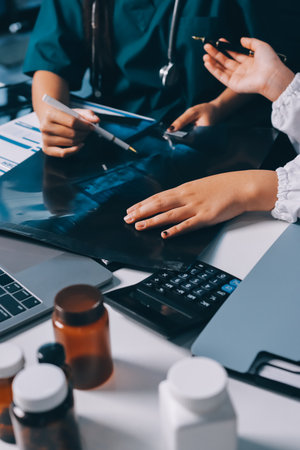 Group of doctors attending seminar in hospital lecture hall with senior physician giving medical presentation and professional training session on healthcare practicesの写真素材