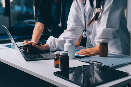 Group of doctors attending seminar in hospital lecture hall with senior physician giving medical presentation and professional training session on healthcare practicesの写真素材