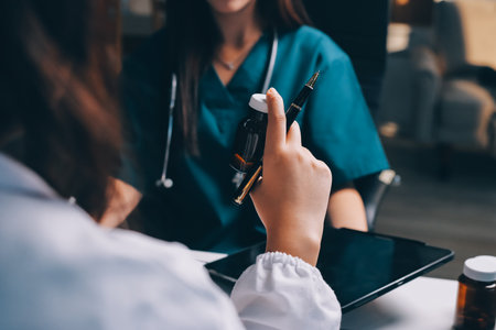 Group of doctors attending seminar in hospital lecture hall with senior physician giving medical presentation and professional training session on healthcare practicesの写真素材