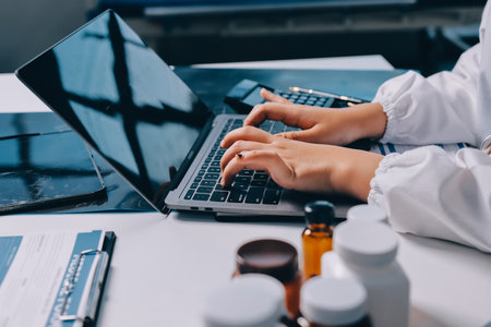 Group of doctors attending seminar in hospital lecture hall with senior physician giving medical presentation and professional training session on healthcare practicesの写真素材
