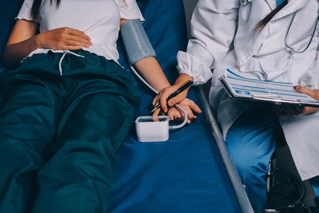Nurse measuring blood pressure of elderly woman at table, closeup. Assisting senior generationの写真素材