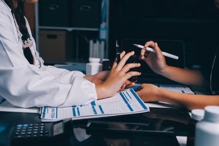 Group of doctors attending seminar in hospital lecture hall with senior physician giving medical presentation and professional training session on healthcare practicesの写真素材