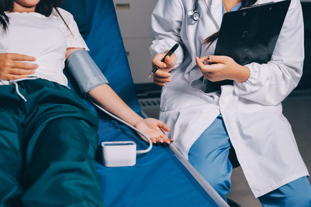 Nurse measuring blood pressure of elderly woman at table, closeup. Assisting senior generationの写真素材