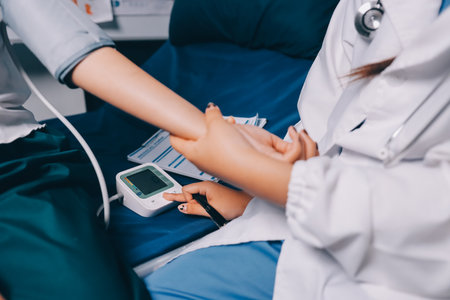 Nurse measuring blood pressure of elderly woman at table, closeup. Assisting senior generationの写真素材