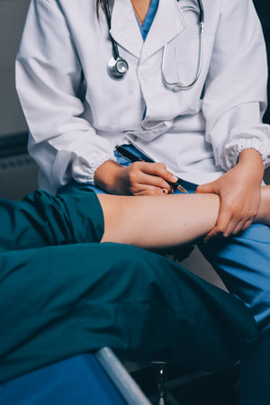 Rehabilitation therapy Professional male physiotherapists working in rehabilitation centers while treating male patients with leg and muscle pain.の写真素材