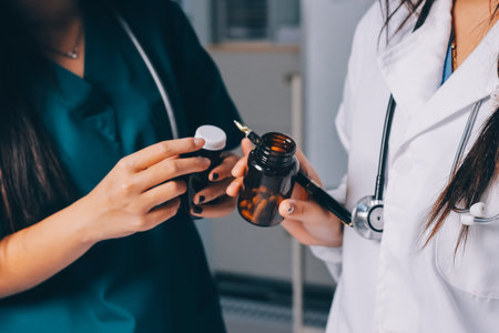 Group of doctors attending seminar in hospital lecture hall with senior physician giving medical presentation and professional training session on healthcare practicesの写真素材