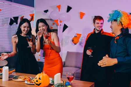 Joyful Halloween party with coworkers in costumes, celebrating with drinks and laughter, fostering teamwork and festive spiritの写真素材