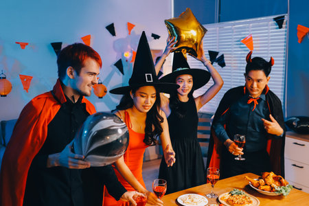 Joyful office Halloween party with coworkers in costumes, celebrating with drinks and laughter, fostering teamwork and festive spiritの写真素材