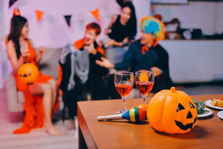 Joyful office Halloween party with coworkers in costumes, celebrating with drinks and laughter, fostering teamwork and festive spiritの写真素材