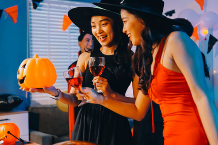 Joyful office Halloween party with coworkers in costumes, celebrating with drinks and laughter, fostering teamwork and festive spiritの写真素材