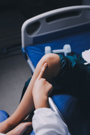 Rehabilitation therapy Professional male physiotherapists working in rehabilitation centers while treating male patients with leg and muscle pain.の写真素材