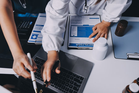 Group of doctors attending seminar in hospital lecture hall with senior physician giving medical presentation and professional training session on healthcare practicesの写真素材