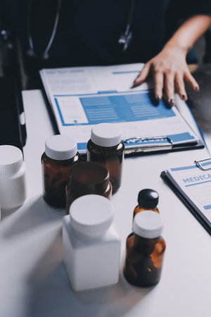Group of doctors attending seminar in hospital lecture hall with senior physician giving medical presentation and professional training session on healthcare practicesの写真素材