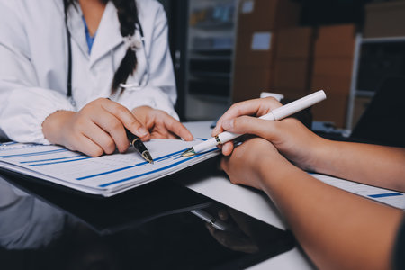 Group of doctors attending seminar in hospital lecture hall with senior physician giving medical presentation and professional training session on healthcare practicesの写真素材