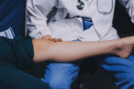 Rehabilitation therapy Professional male physiotherapists working in rehabilitation centers while treating male patients with leg and muscle pain.の写真素材