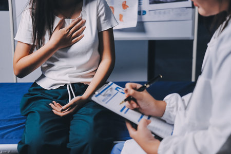 Compassionate Female Doctor Examining Senior Patient in Hospital Bed, Showing Empathy and Careの写真素材