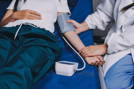 Nurse measuring blood pressure of elderly woman at table, closeup.