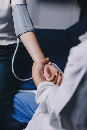 Nurse measuring blood pressure of elderly woman at table, closeup. Assisting senior generationの写真素材