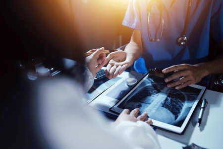 Doctors are meeting at the hospital to discuss treatment options and share experiences with colleagues.の写真素材