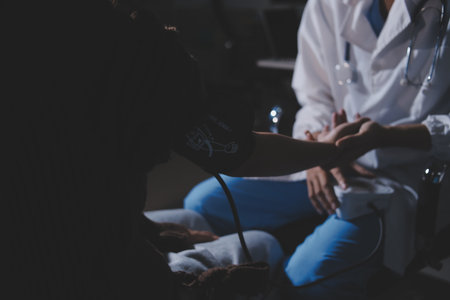 The doctor measures blood pressure to the patientの写真素材