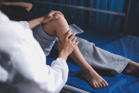 Rehabilitation therapy Professional male physiotherapists working in rehabilitation centers while treating male patients with leg and muscle pain.の写真素材