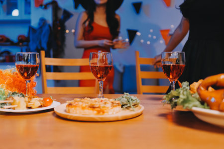 Joyful Halloween party with coworkers in costumes, celebrating with drinks and laughter, fostering teamwork and festive spiritの写真素材