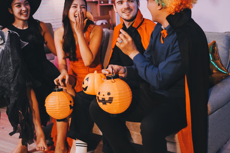 Joyful office Halloween party with coworkers in costumes, celebrating with drinks and laughter, fostering teamwork and festive spiritの写真素材