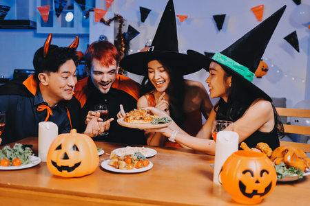 Joyful Halloween party with coworkers in costumes, celebrating with drinks and laughter, fostering teamwork and festive spiritの写真素材
