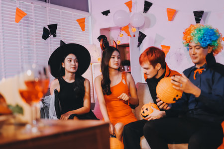 Joyful office Halloween party with coworkers in costumes, celebrating with drinks and laughter, fostering teamwork and festive spiritの写真素材