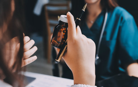 Group of doctors attending seminar in hospital lecture hall with senior physician giving medical presentation and professional training session on healthcare practicesの写真素材