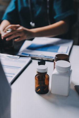 Group of doctors attending seminar in hospital lecture hall with senior physician giving medical presentation and professional training session on healthcare practicesの写真素材