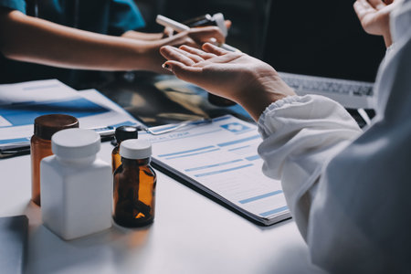 Group of doctors attending seminar in hospital lecture hall with senior physician giving medical presentation and professional training session on healthcare practicesの写真素材