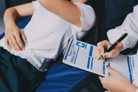 Compassionate Female Doctor Examining Senior Patient in Hospital Bed, Showing Empathy and Careの写真素材