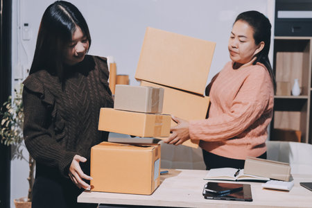 Asian woman selling clothes on camera live broadcast on social network at home, Online selling clothes on social media. Blogger woman influencer, SME retail store owner.の写真素材