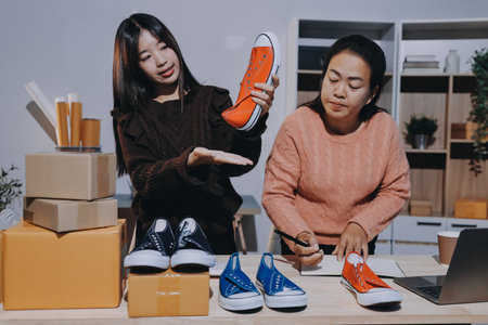 Asian woman selling clothes on camera live broadcast on social network at home, Online selling clothes on social media. Blogger woman influencer, SME retail store owner.の写真素材