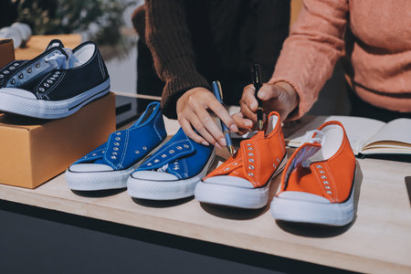 Asian woman selling clothes on camera live broadcast on social network at home, Online selling clothes on social media. Blogger woman influencer, SME retail store owner.の写真素材