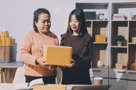 Asian woman selling clothes on camera live broadcast on social network at home, Online selling clothes on social media. Blogger woman influencer, SME retail store owner.の写真素材