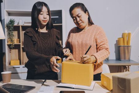 Asian woman selling clothes on camera live broadcast on social network at home, Online selling clothes on social media. Blogger woman influencer, SME retail store owner.の写真素材