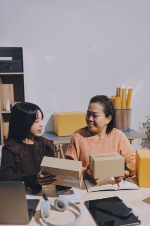 Asian woman selling clothes on camera live broadcast on social network at home, Online selling clothes on social media. Blogger woman influencer, SME retail store owner.の写真素材