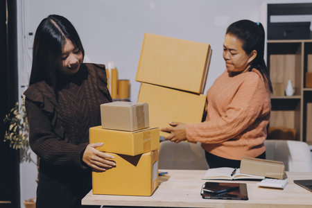 Asian woman selling clothes on camera live broadcast on social network at home. Online selling clothes on social media. Blogger woman influencer, SME retail store owner.の写真素材