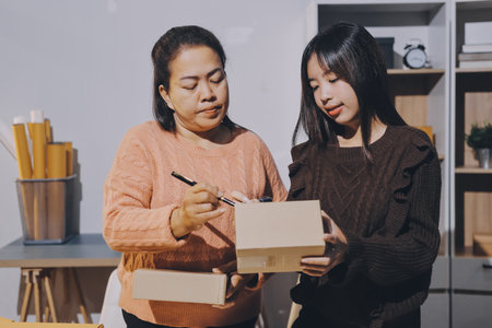 Asian woman describe selling clothes on camera live broadcast on social network at home, Online selling clothes on social media. Blogger woman influencer, SME retail store owner.の写真素材