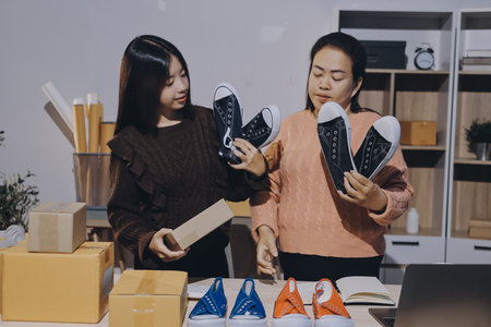 Asian woman selling clothes on camera live broadcast on social network at home, Online selling clothes on social media. Blogger woman influencer, SME retail store owner.の写真素材