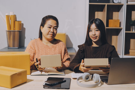 Asian woman describe selling clothes on camera live broadcast on social network at home, Online selling clothes on social media. Blogger woman influencer, SME retail store owner.の写真素材