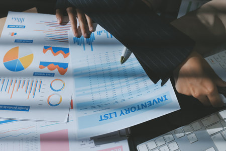 Close up high angle Asian businesswoman working with her coworker in meeting roomの写真素材