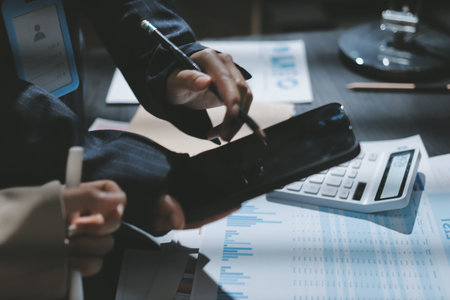 Close up high angle Asian businesswoman working with her coworker in meeting roomの写真素材