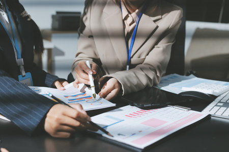 Close up high angle Asian businesswoman working with her coworker in meeting roomの写真素材